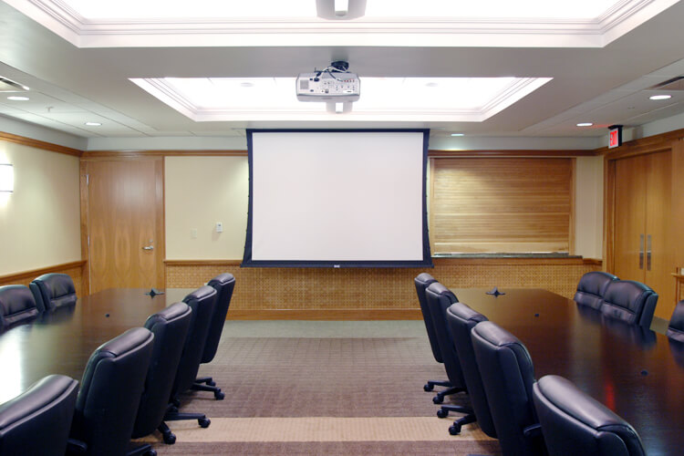 conference room with two tables and a projector screen