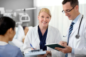 2 doctors using ipads to chart a patient's progress