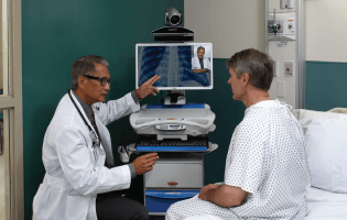 doctor uses monitor to show test results