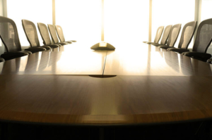 video conference room, conference table with chairs, back lit window