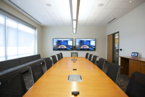 video conference room, long table with chairs and video screens