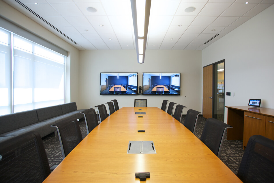 large meeting room with two displays