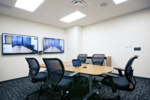 small group meeting room with dual displays, camera and a touch panel