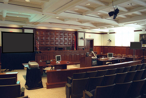 Courtroom with projector, screen and monitors on the tables