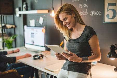 woman checking financial software on av equipment