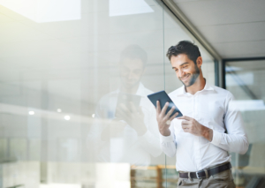 Cropped shot of a young businessman using a digital tablet in his office