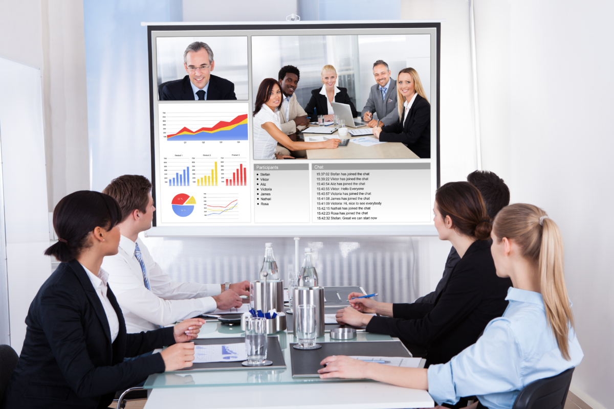 Businesspeople Sitting In A Conference Room Looking At Screen, virtual meeting