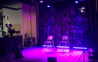two chairs on stage with custom lighting
