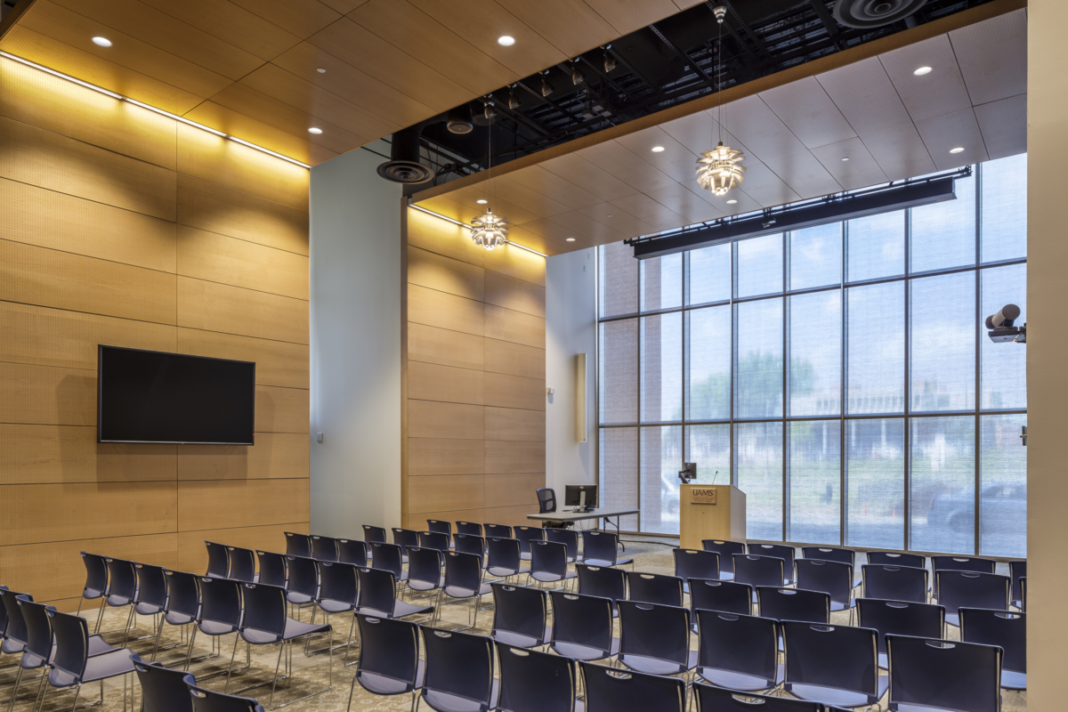 lecture hall with large display, speakers projector and podium