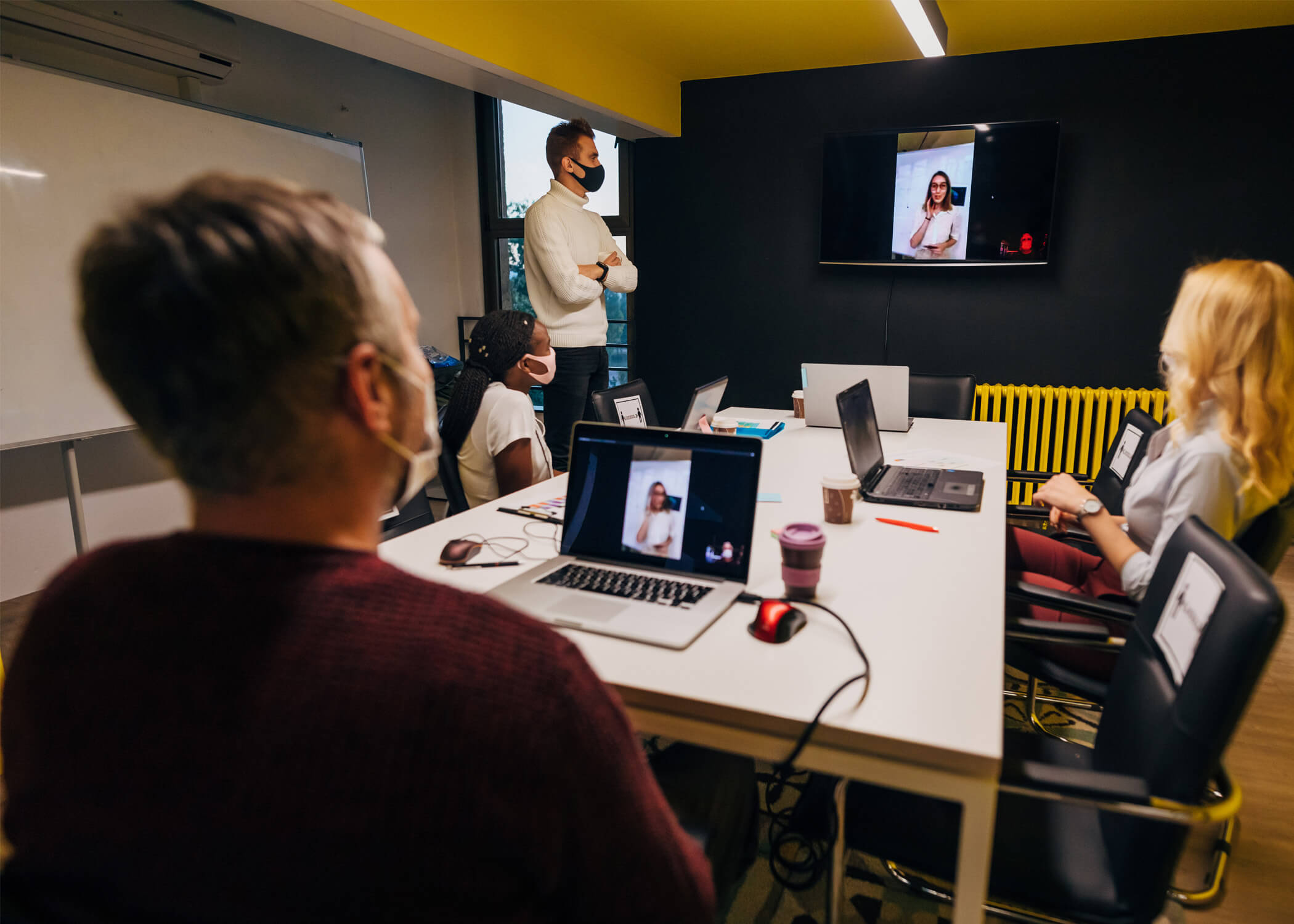 people wearing masks in conference room Returning to Work