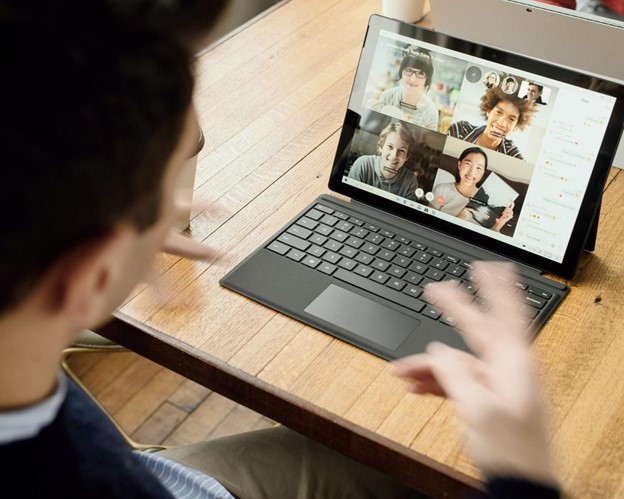 man with laptop in video meeting