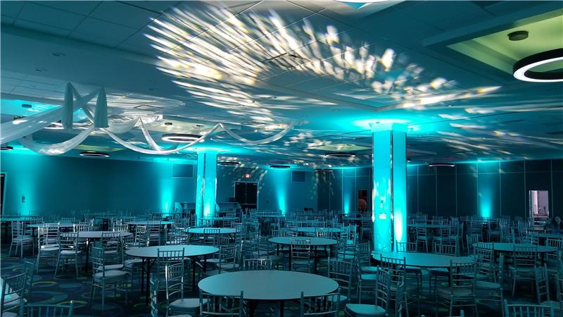 blue and white creative lighting on the ceiling at an event