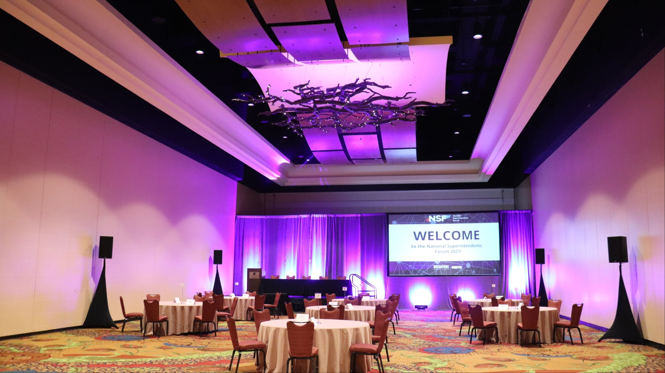 purple lighting at a large conference room
