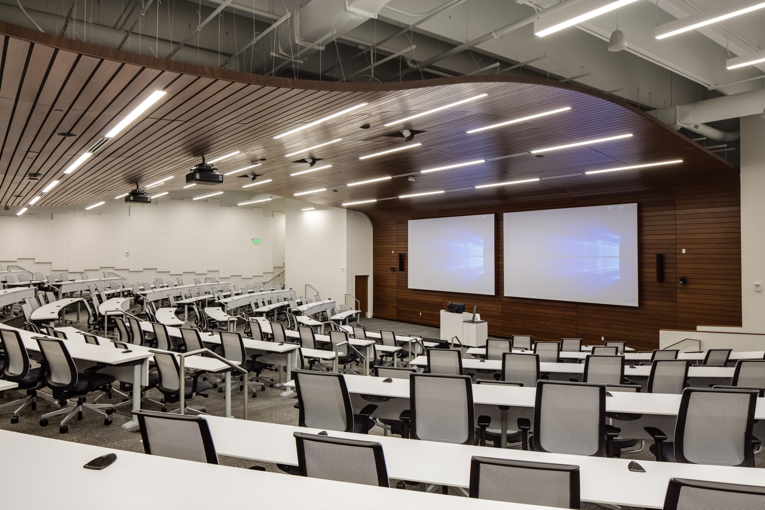 wavy ceiling classroom with dual monitors and a projector