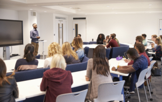 University students study in a classroom with male lecturer
