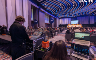audio technician working at mixing console and laptop