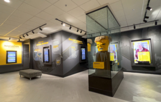 exhibit space with multiple wall‑mounted monitors