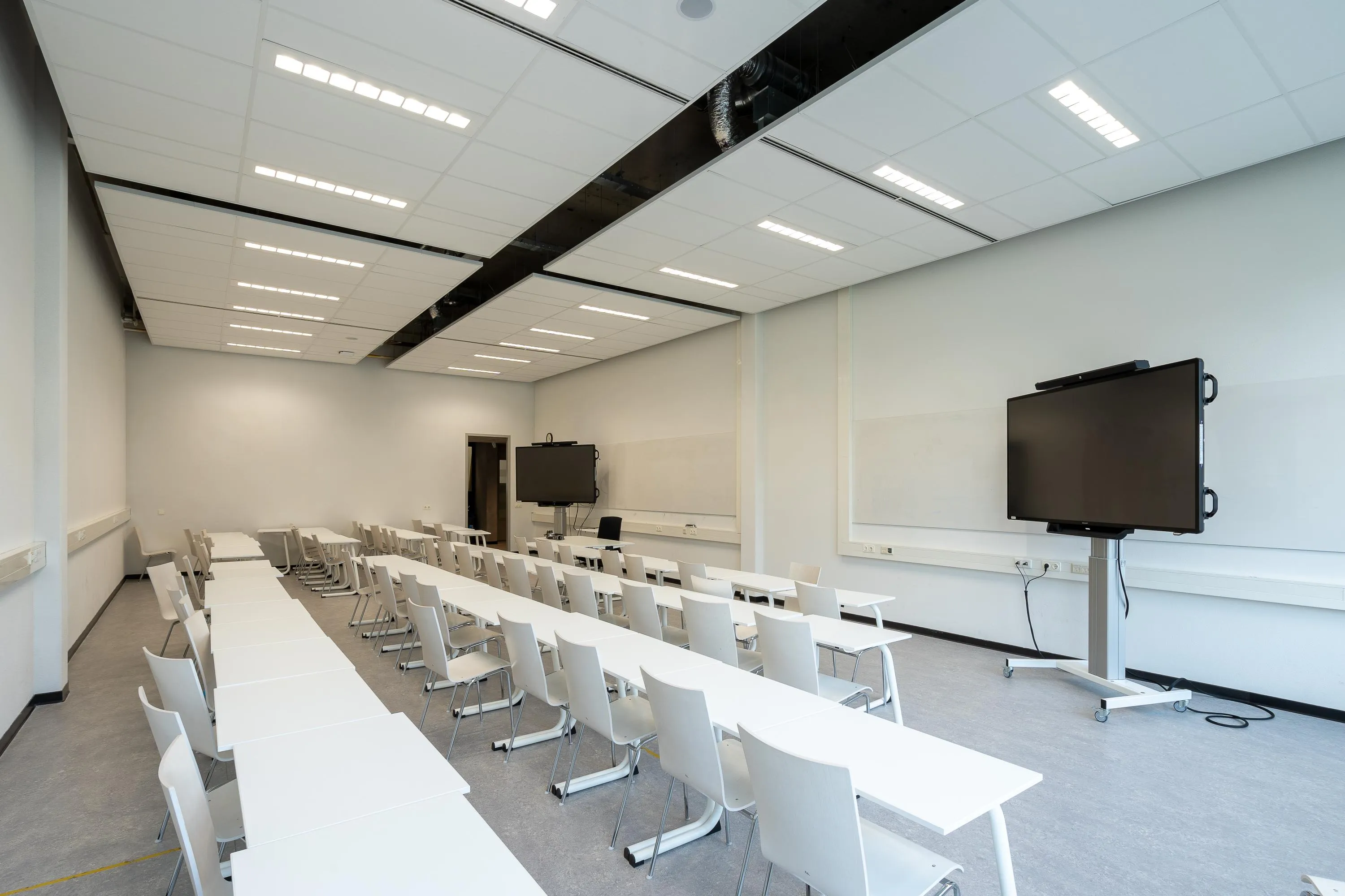 empty classroom with two large monitors