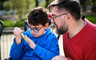 boy and man interacting over a smartphone