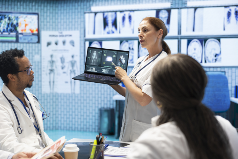 nurse holding laptop displaying scan images device laptop