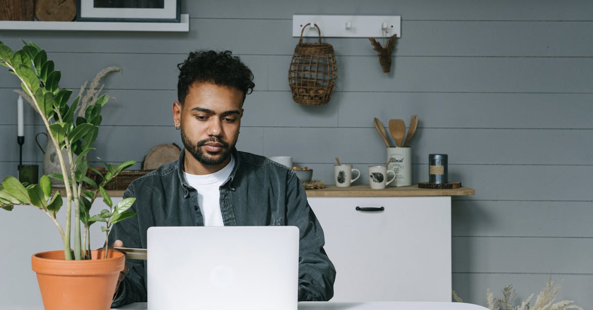 man working on laptop at table