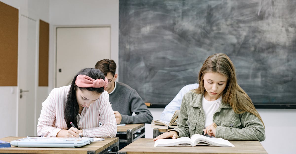 students writing with notebooks at desks