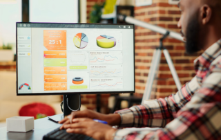 man working on business analytics with monitor
