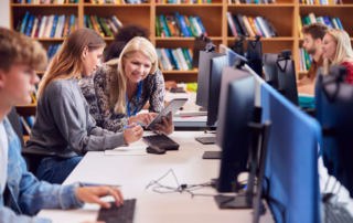students at desktop PCs and tablet