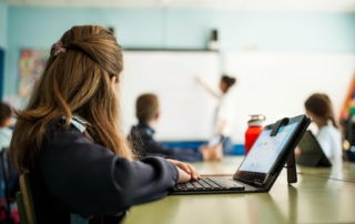 student using tablet keyboard in classroom