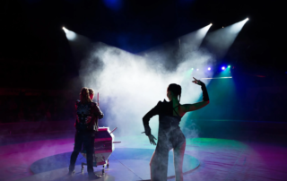 performers on stage with smoke and spotlights