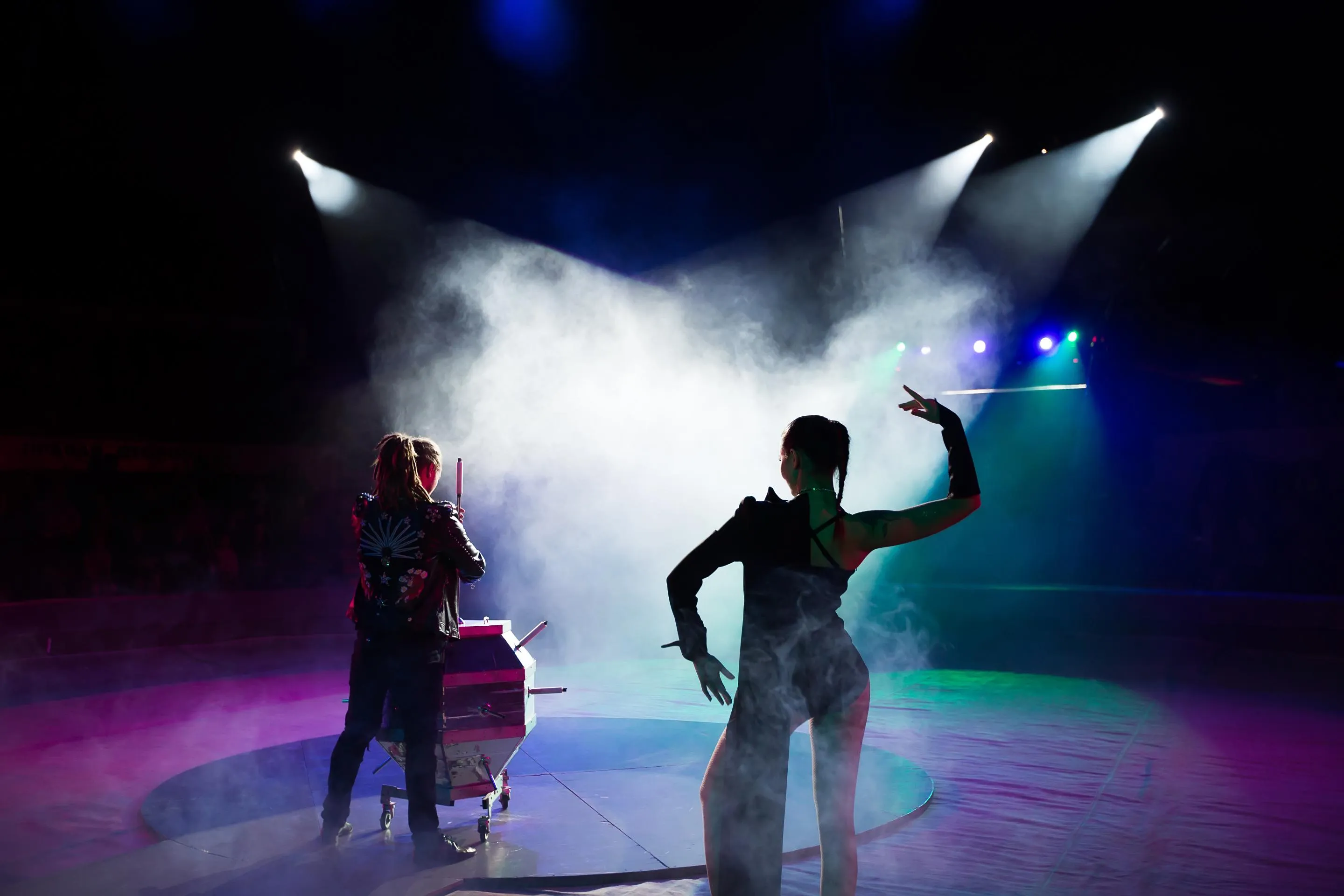 performers on stage with smoke and spotlights