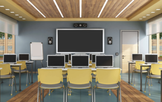 classroom with rows of laptops on yellow chairs