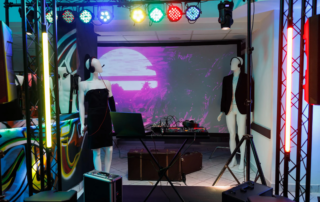 mannequins with headphones and laptop dj controller under stage lights