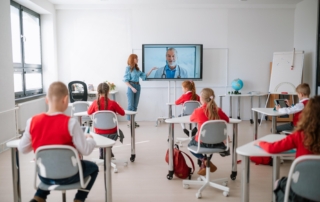 teacher showing virtual doctor on classroom screen