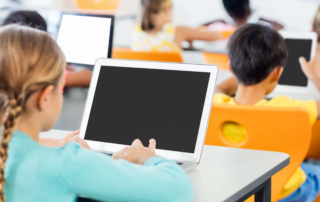 student using laptop in classroom