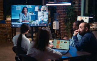 team video conferencing with monitor and laptops