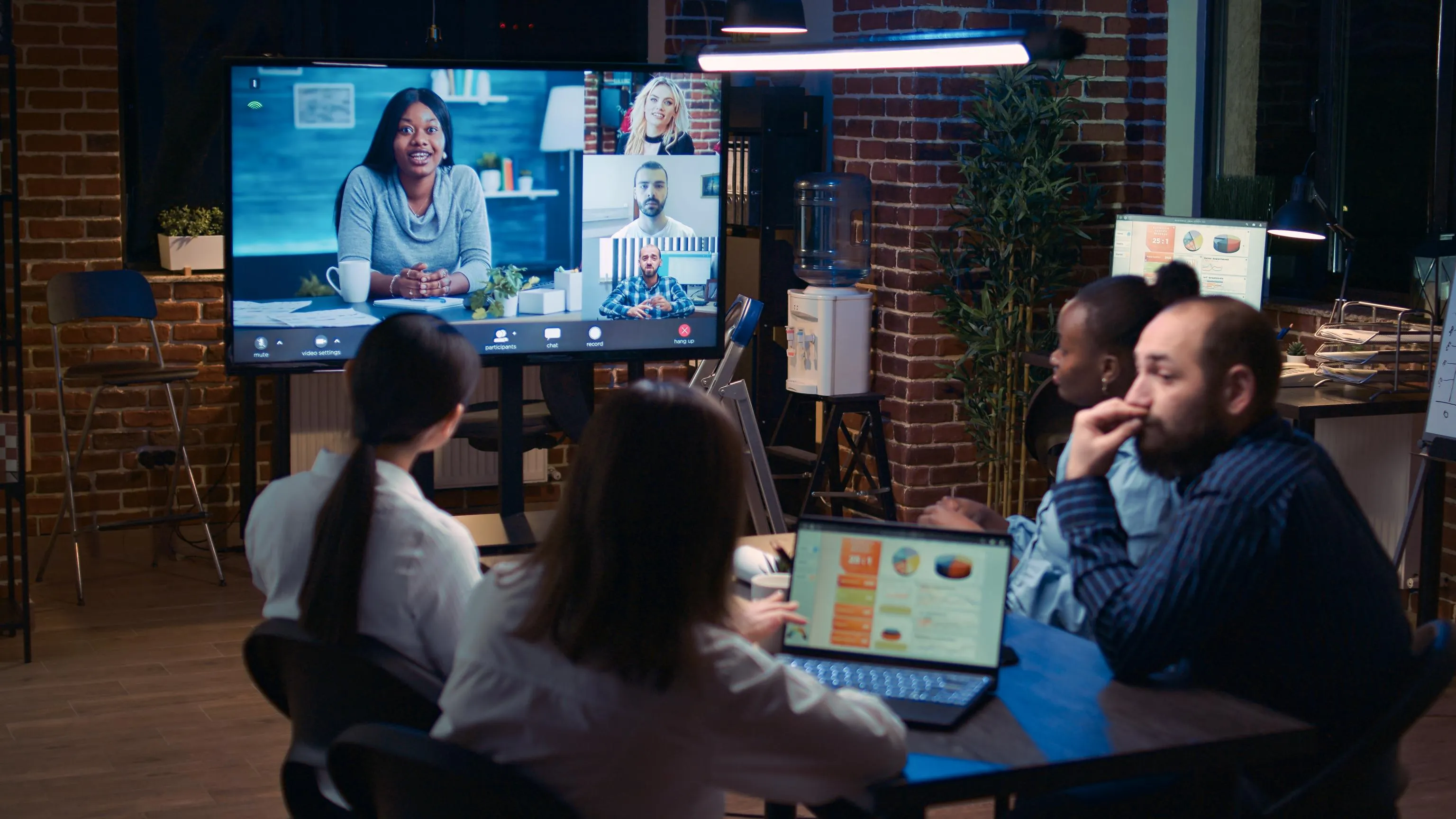team video conferencing with monitor and laptops