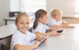 kids using tablets at school desk