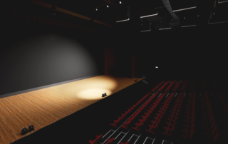 Spotlighted empty theatre stage with wooden floor and seating