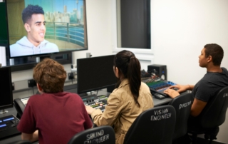 vision engineer and sound engineer at control consoles with monitors device monitors