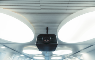 Modern ceiling with round lights and suspended projector unit