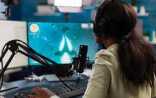 Woman livestreaming video game with mic headset and dual monitors