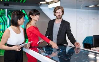 colleagues using a large interactive touchscreen table