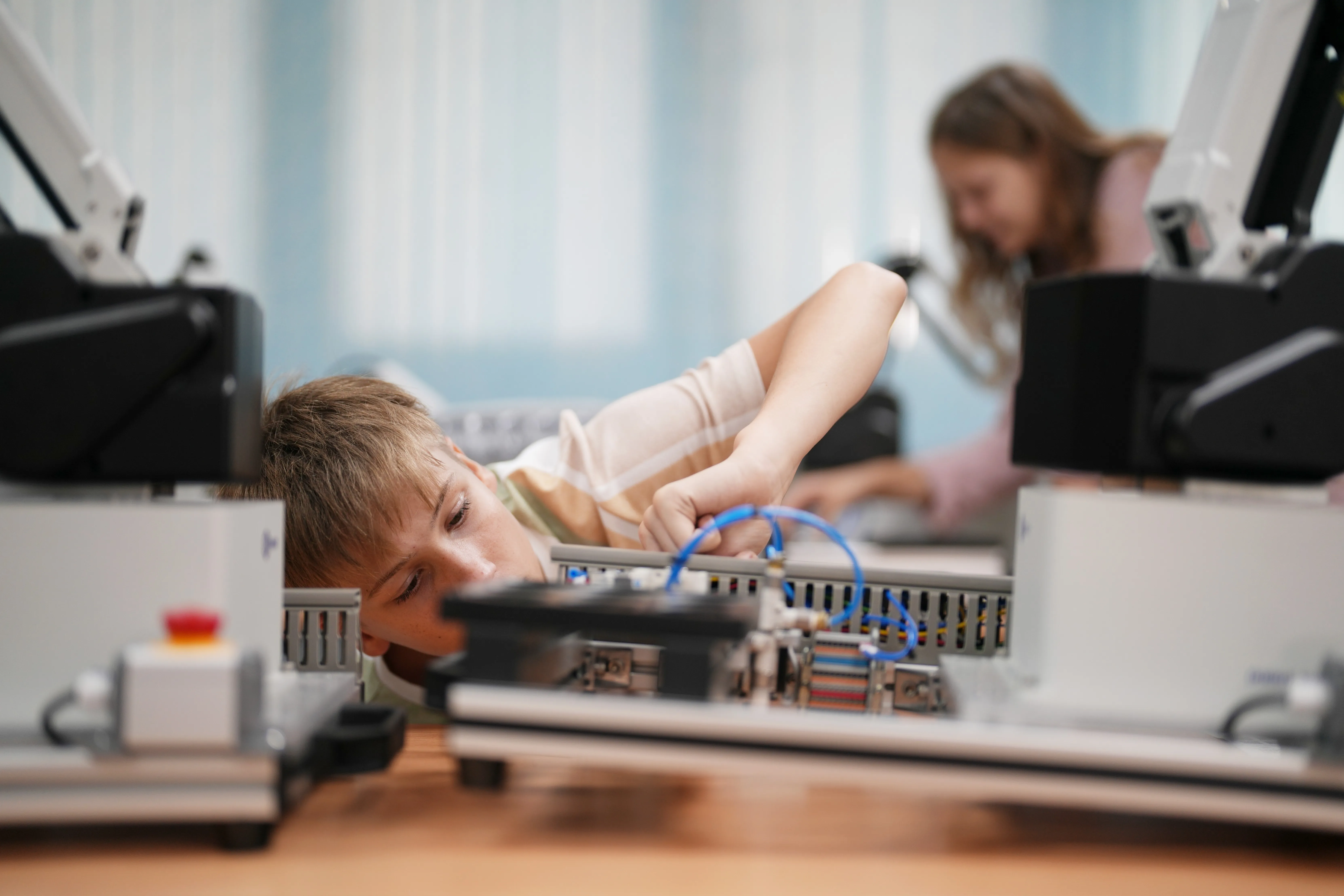 student inspecting robotic machinery device industrial machinery