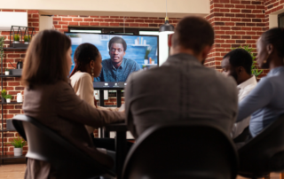 Video call on large monitor during office team meeting