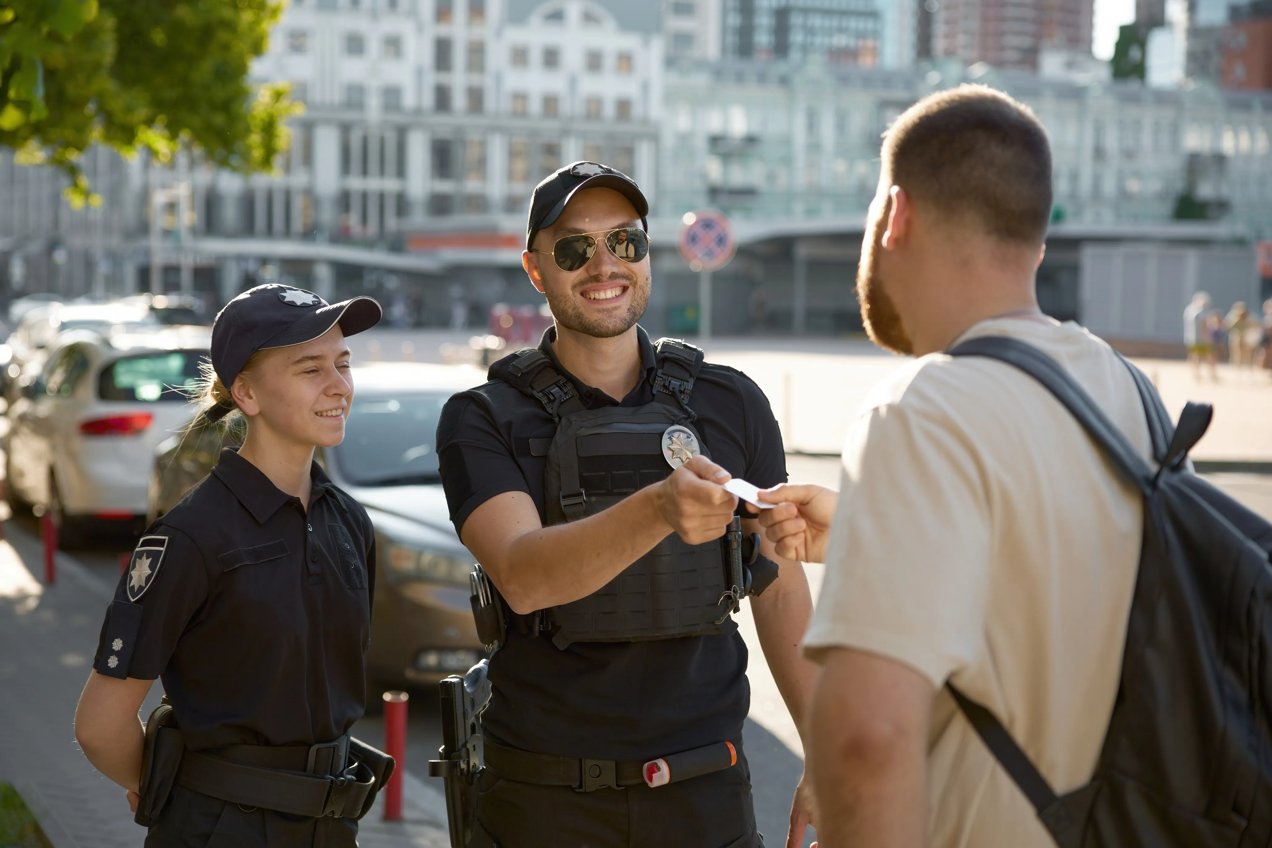 police officer handing id to civilian outdoors