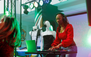 female dj wearing headphones using laptop