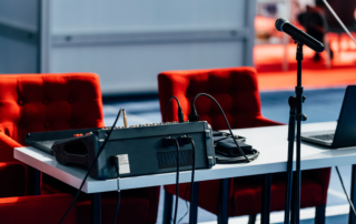 table microphone stand with mixer and laptop