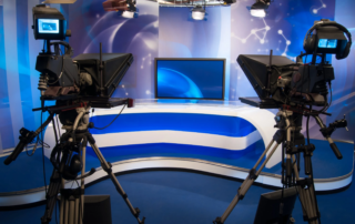 Television studio set with large cameras and central display monitor