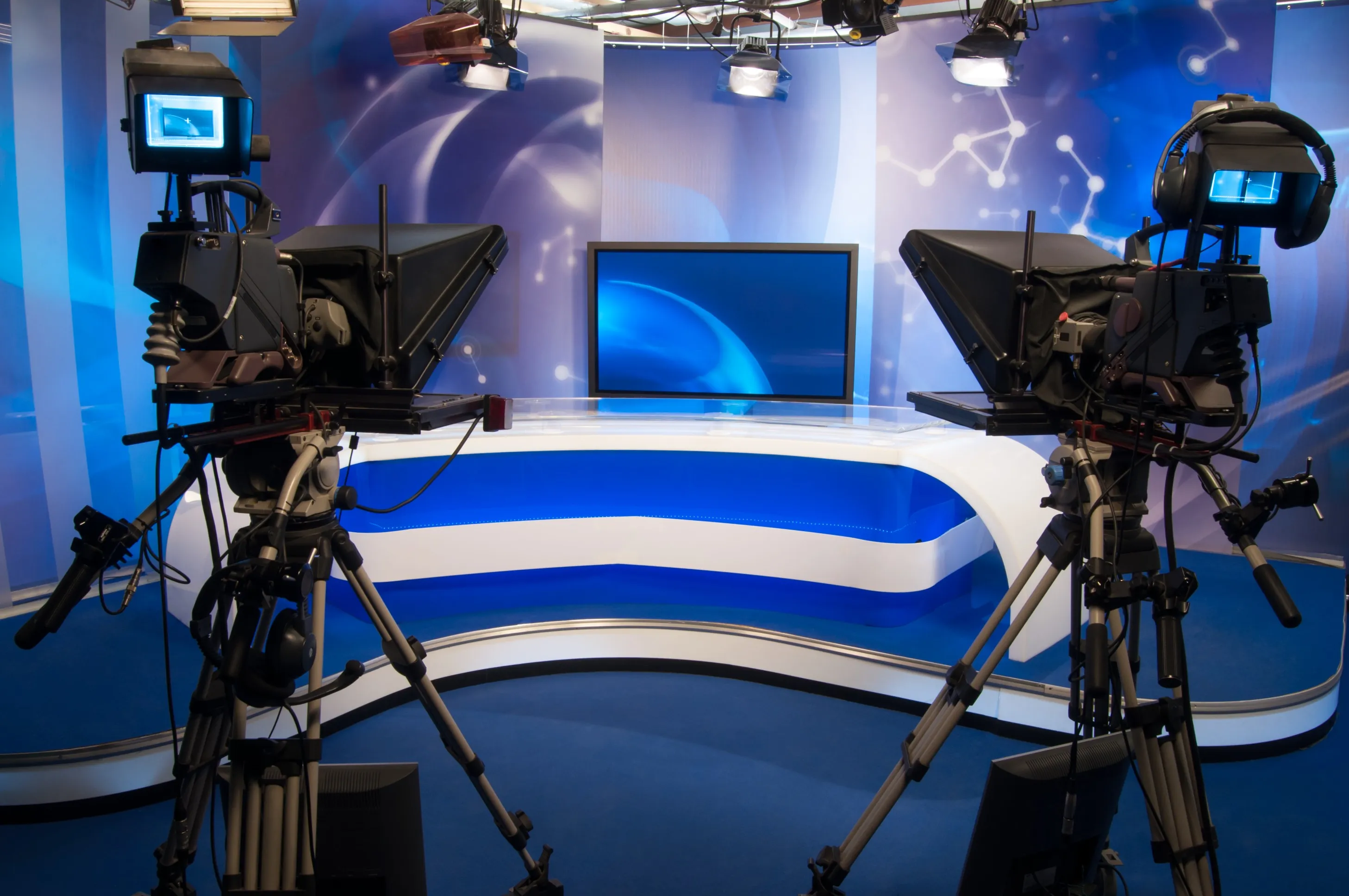 Television studio set with large cameras and central display monitor